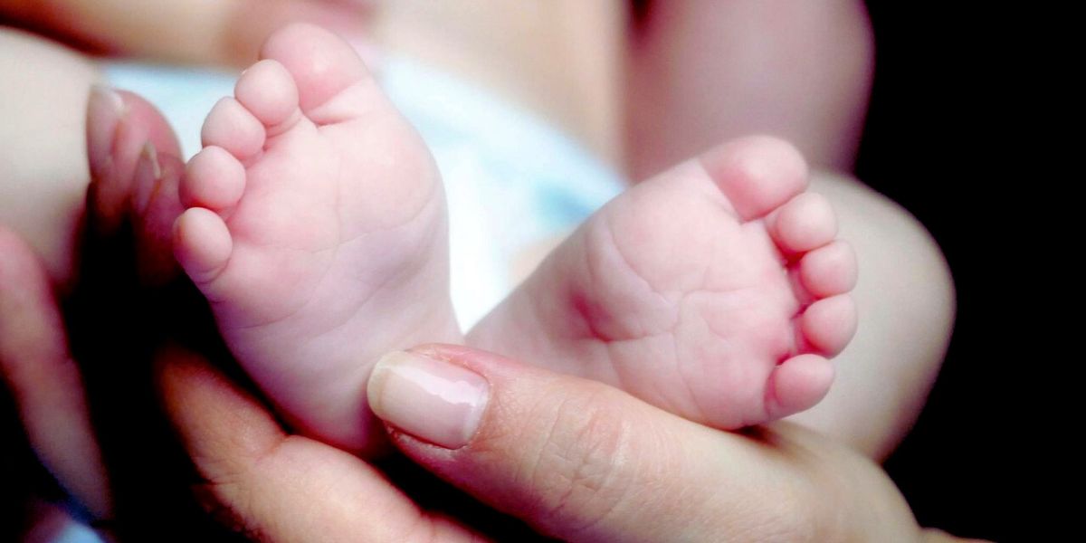 Baby soft feet in mother's hands